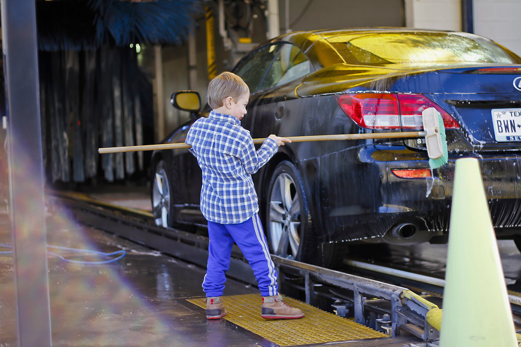 child washing car at car wash birthday party