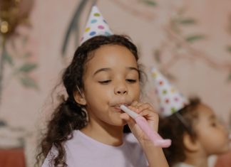 child with party blower, DIY birthday party tips