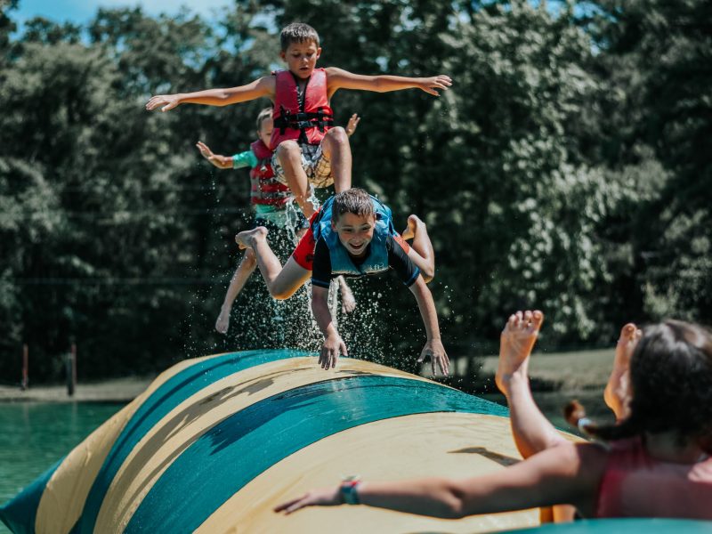 kids bouncing on float at Camp Huawni Texas sleepaway camps