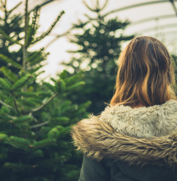 View of a woman from behind in a Christmas tree farm tent