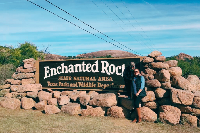 couple at entrance to Enchanted Rock in winter