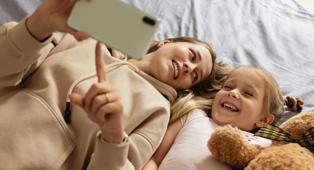 mom and daughter looking at phone, kids privacy on social media