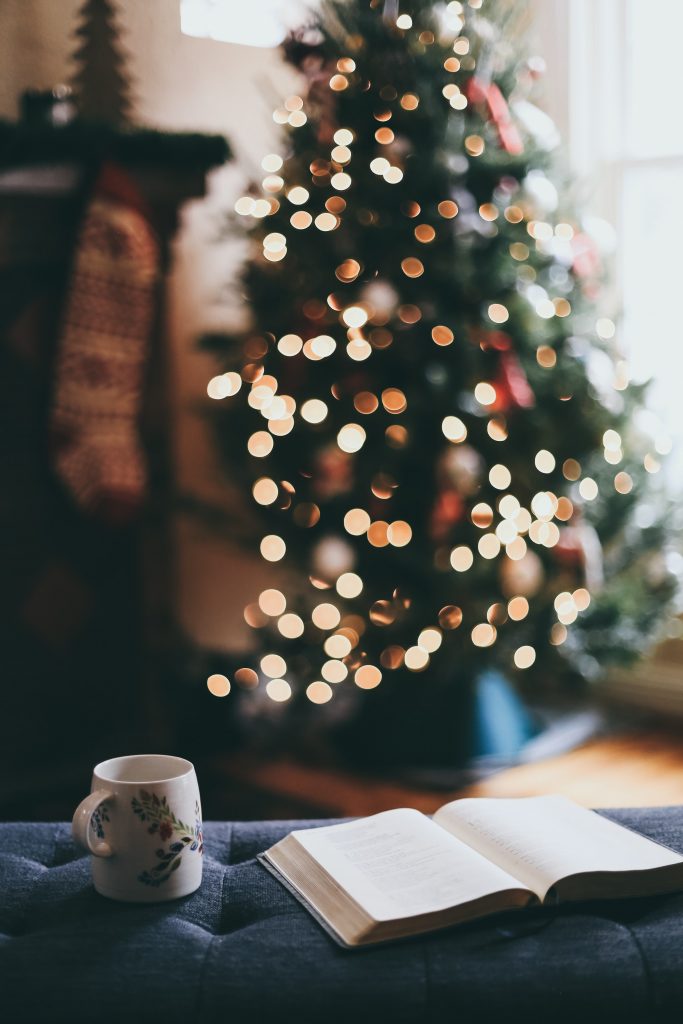 holiday book recommendations: coffee, christmas tree, and open book