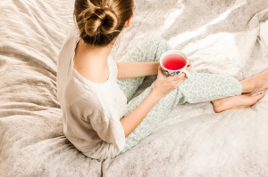 woman on bed with a cup of tea from texas travel bucket list