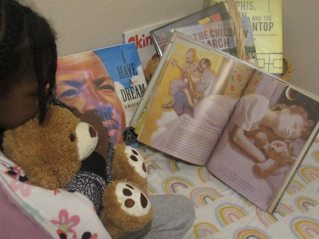 child reading the green book, how to teach kids about mlk
