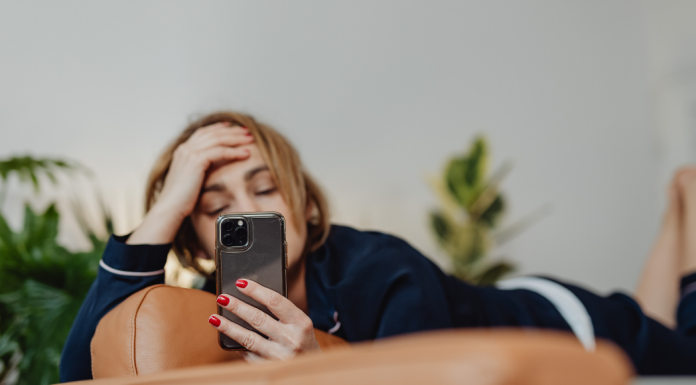 tired woman looking at iPhone, social media detox