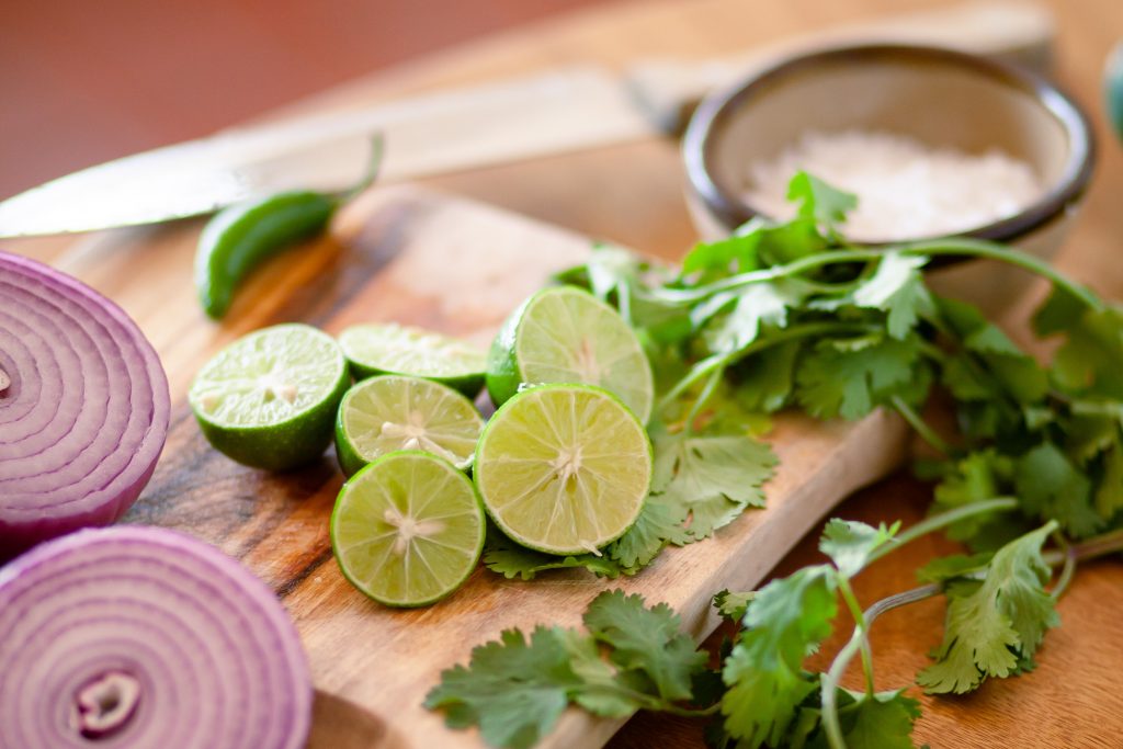 onion, lime, and cilantro on cutting board, meal planning time savers for moms