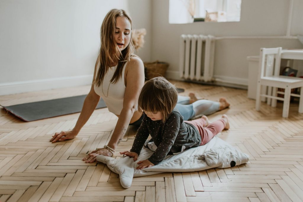 mother and small child doing yoga, indoor workouts for moms