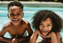 two kids smiling in swimming pool, YMCA Dallas summer camp