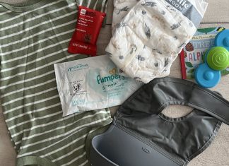 What I actually carry in my bag: diapers, wipe, snack, onesie, toy, book, bib