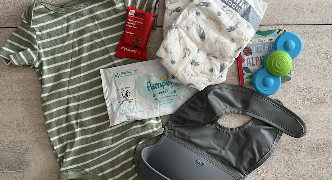 diaper bag essentials: diapers, wipe, snack, onesie, toy, book, bib