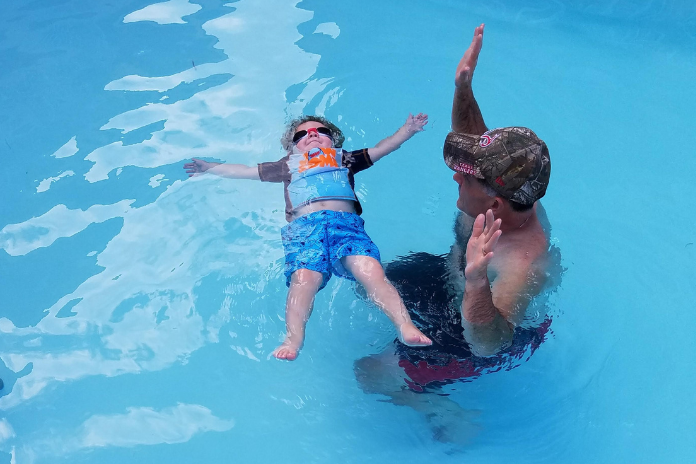 child floating safely in water