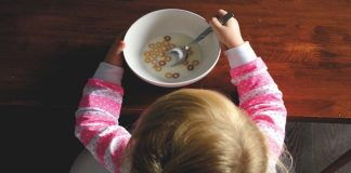 toddler with cereal bowl