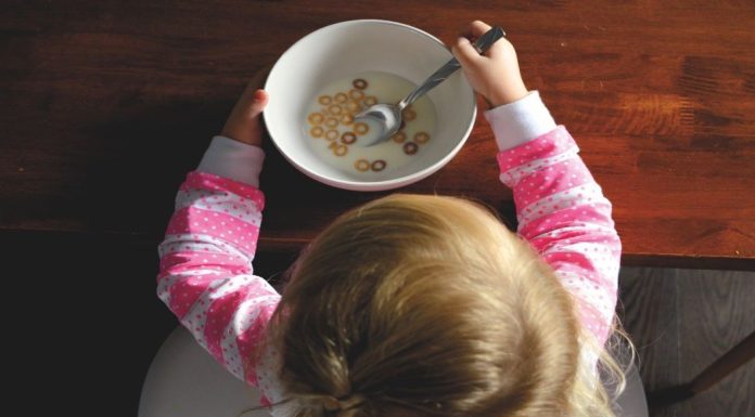 toddler with cereal bowl