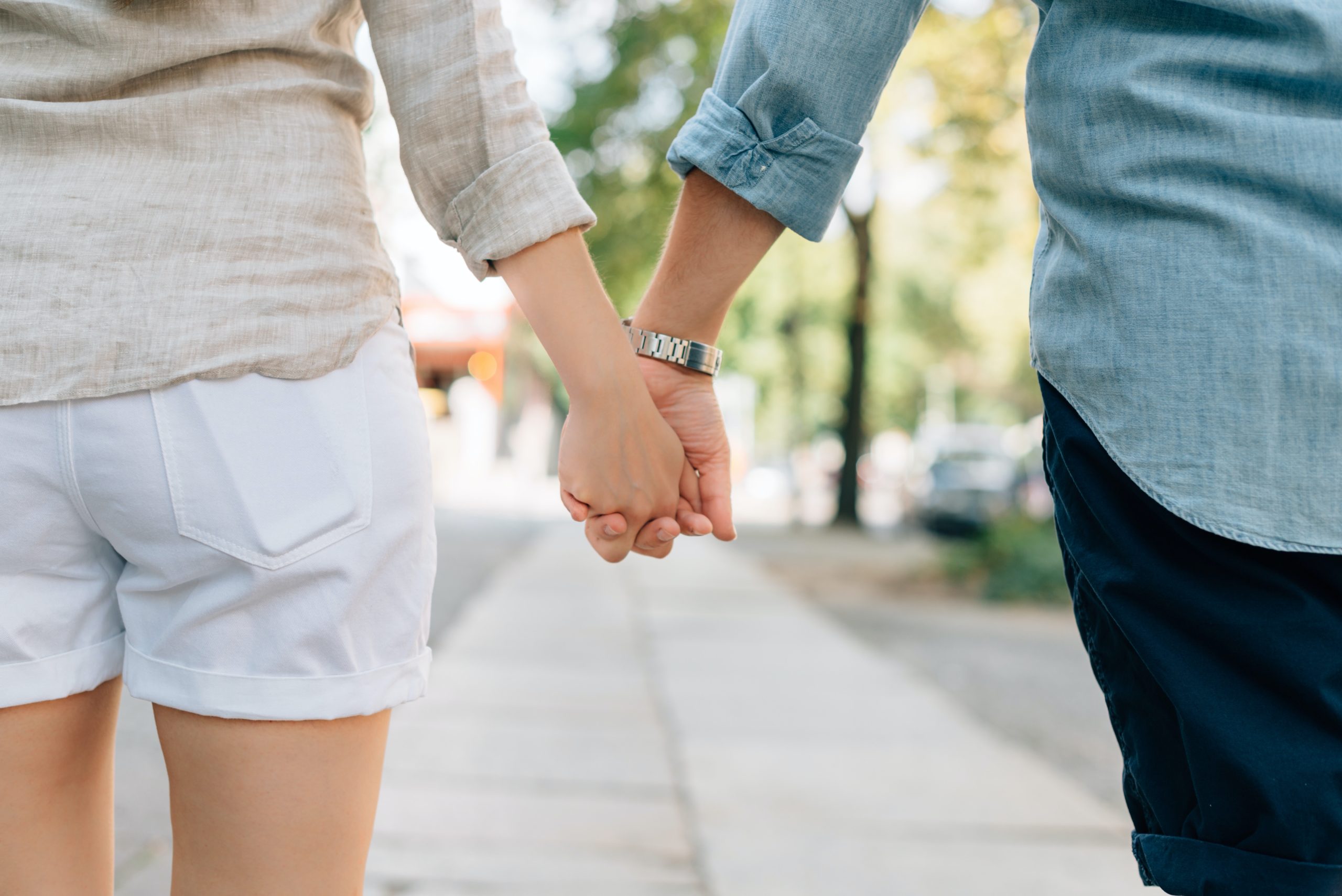 A man and woman hold hands.