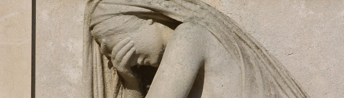 stone statue of a sad woman with her head in her hand