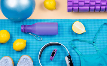 Workout accessories like a water bottle, headphones, sports bra, and more.