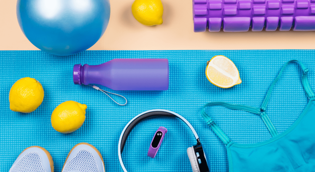 Workout accessories like a water bottle, headphones, sports bra, and more.
