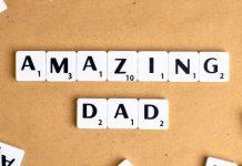 Ten white tiles with black writing spell Amazing Dad with a corkboard background.