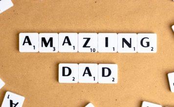 Ten white tiles with black writing spell Amazing Dad with a corkboard background.
