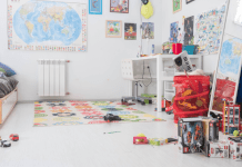 An image of a children's playroom with a desk and toys on the floor.