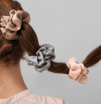 A woman wears three scrunchies in her hair.