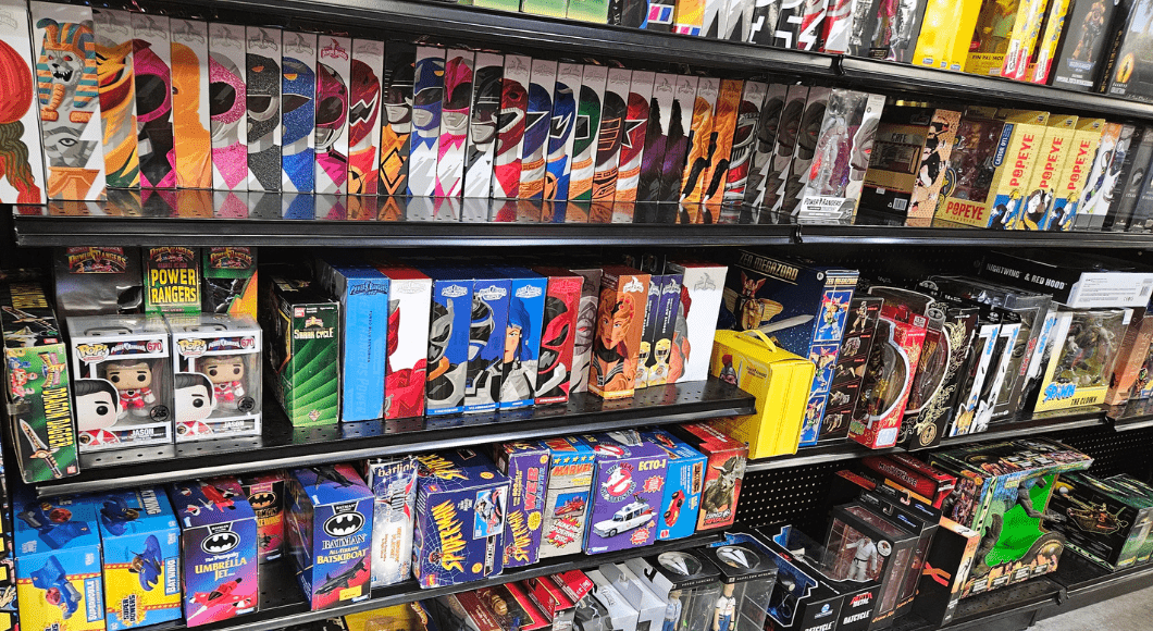Shelves of vintage toys including Power Rangers, DC and Marvel comics action figures.