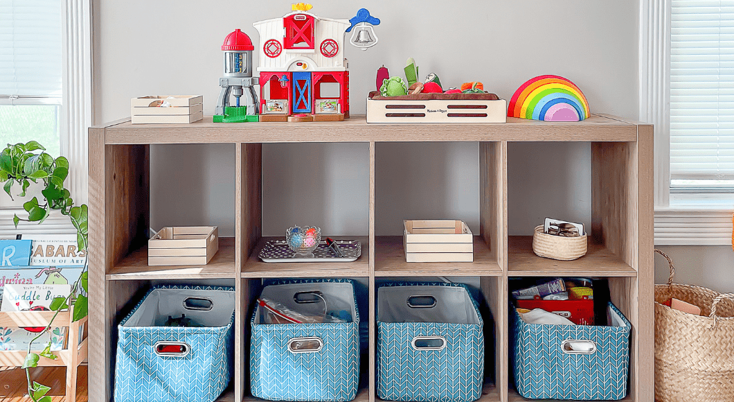 shelving unit with 4 blue bins and an assortment of toys