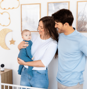 A mother and father in their baby's nursery with a Harbor baby monitor camera
