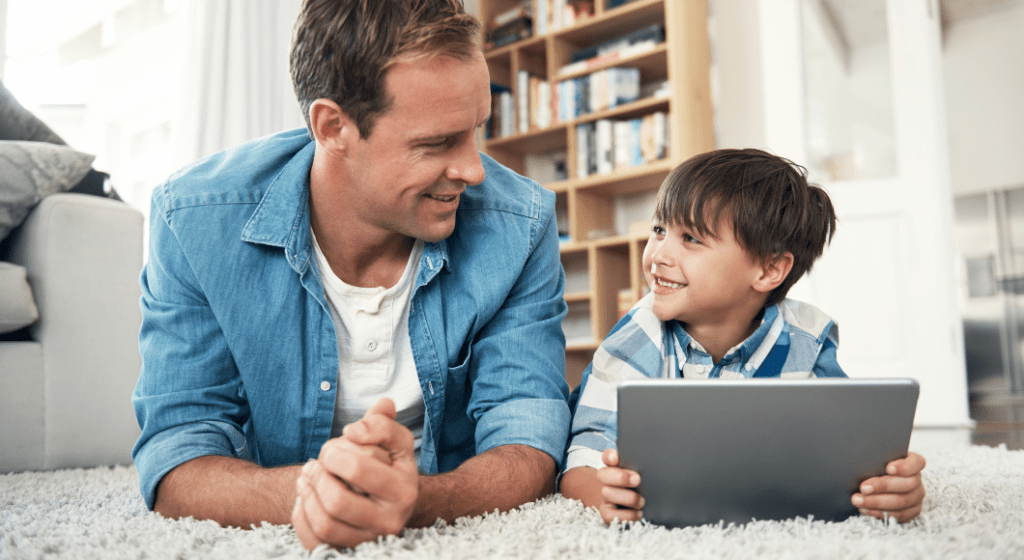 A father and son use a tablet together.